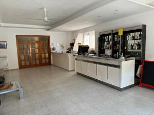 a room with a bar and a counter with alcohol at Hotel Tania in Casa Giosafat