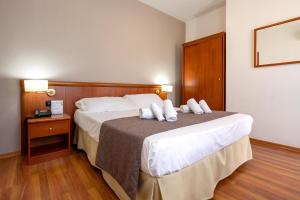 Postel nebo postele na pokoji v ubytování Garden Hotel