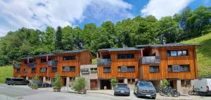 a building with cars parked in a parking lot at Chalet Ablon in Saalbach Hinterglemm