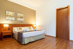 Postel nebo postele na pokoji v ubytování Garden Hotel