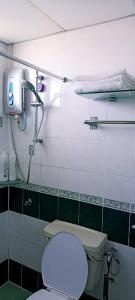 a bathroom with a toilet and a shower at Anneliese suite Glory Beach Resort in Port Dickson