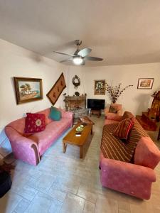 a living room with two couches and a piano at Petra Maisonettes in Kariá