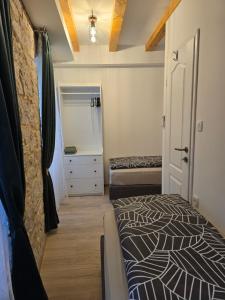 a bedroom with a bed and a dresser and a mirror at Apartments Rose 5 in Cres