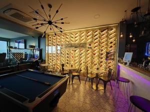 a pool table in a bar with tables and chairs at ApartHotel421 by Seafront Collection in Blackpool