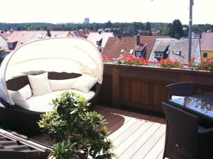 a white couch sitting on top of a balcony at Helles, modernes Appartement in Nuremberg