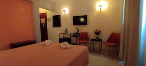 a room with a table and two red chairs at Hotel Alnacir in Faro