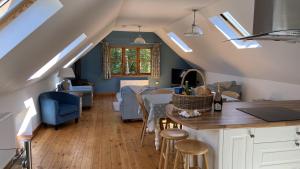 a kitchen and living room with a table and chairs at East Trayne Holiday Cottages in South Molton