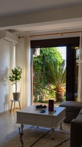 a living room with a coffee table in front of a window at Luka private beach in Dobra Voda