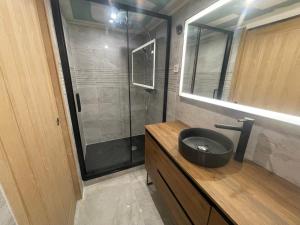 a bathroom with a shower and a black sink at Chalet les brimbelles in Le Tholy +39 photos