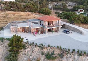 an overhead view of a house on a hill at Lithos Apartments in Evdilos