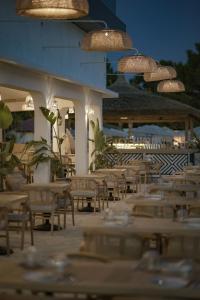 a row of tables and chairs on a patio at Glenn Hotel & Beach in Ayvacık