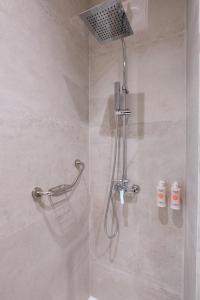 a shower with a shower head in a bathroom at Hotel El Toro Tanger in Tangier