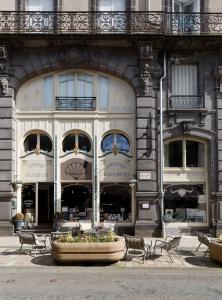 a large building with a fountain in front of it at Le Boudoir Monsieur Aurélien - Suite Hôtelière in Le Mont-Dore
