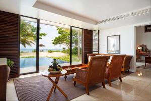 a dining room with a view of the ocean at The Residence Zanzibar in Kizimkazi