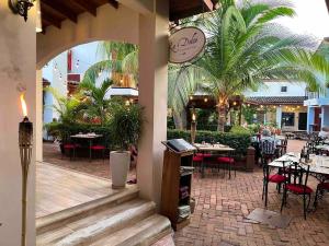 an outdoor patio with tables and chairs and a restaurant at Beach Dreams Coco - 60 meters from Beach in Coco