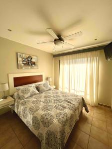a bedroom with a bed and a ceiling fan at Stylish & Comfortable Condo with Balconies in Coco +35 photos
