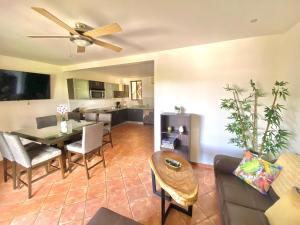 a living room with a table and a dining room at Modern Condo with a Rooftop Patio in Coco