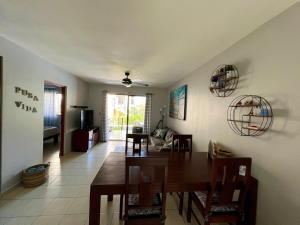a dining room and living room with a table and chairs at Sea Bottom Ground Condo in Coco