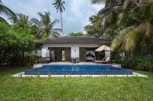 a swimming pool in front of a villa at The Residence Zanzibar in Kizimkazi