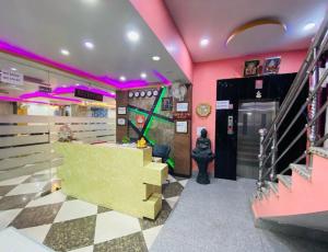a store with pink walls and a checkered floor at Basant Vihar International in Gaya