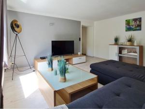 a living room with a couch and a coffee table at Wohnung am Waldrand am Tanneneck in Plettenberg