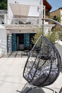 a metal swing in front of a house at PositiveSpace Kalamata Heights in Kalamata