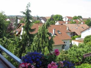 a view of a town from a balcony with flowers at Eva und Wolf Apartments in Sachsenheim