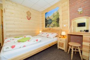 a bedroom with a bed in a wooden room at Krupówki 36 / 8a - Pokój 2 osobowy z widokiem na Giewont in Zakopane
