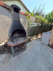 an old brick oven sitting next to a fence at Casa Vlad in Costinesti