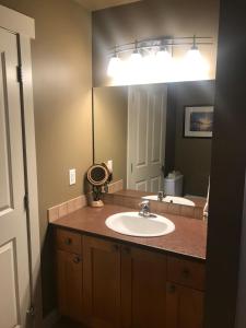 a bathroom with a sink and a large mirror at Sooke Harbour Townhouse - Waterfront 2-Bed Rental in Sooke +25 photos