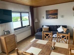 a living room with a couch and a table at Haus Waldesruh, 3 Ferienwohnungen in Hemfurth-Edersee +45 photos