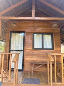 a log cabin with two tables and two windows at Barton Hills in San Vicente