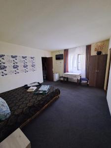 a hotel room with a bed and a window at Casa Vlad in Costinesti