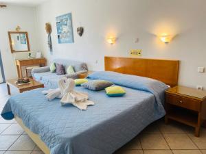 a bedroom with two beds with towels on them at KTM Sunny Villas in Poros