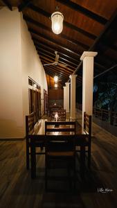 a dining room with a table and chairs in a building at Villa Maria in Bentota