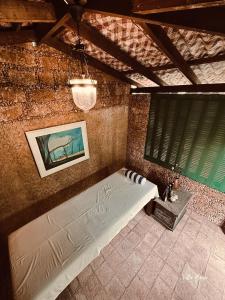 a bedroom with a bed in a brick wall at Villa Maria in Bentota