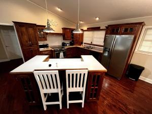 a kitchen with a refrigerator and a counter top at Pet Friendly Fire Pit, Movie Theater, Pool, Sauna in Sevierville