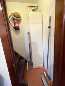 a room with a white refrigerator and a hat on the wall at La Atalaya in Laredo