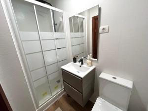 a bathroom with a sink and a toilet and a mirror at La Atalaya in Laredo +15 photos