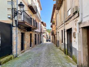 an empty street in an old town at La Atalaya in Laredo