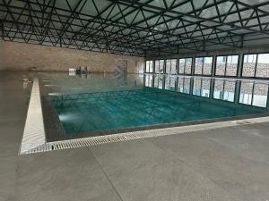a large indoor swimming pool in a building at Mobile Home Bubamara in Drage