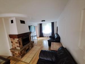 a living room with a couch and a fireplace at Private house 2km from old town in Riga