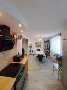 a kitchen and living room with a table and chairs at Private house 2km from old town in Riga