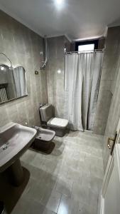 a bathroom with a sink and a toilet and a shower at Maison Martina in Bari