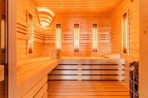a sauna with wood paneling and windows at Chata Wellness Liptov in Ižipovce +52 photos