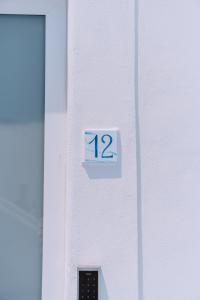 a sign on a door with the number on it at Omare Apartments in Sant'Angelo D'Ischia