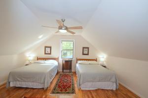 a bedroom with two beds and a ceiling fan at Ahh ... Riverwood in Morton Grove