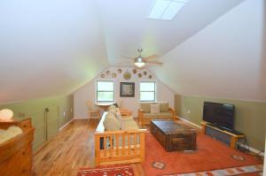 a living room with a couch and a tv at Ahh ... Riverwood in Morton Grove