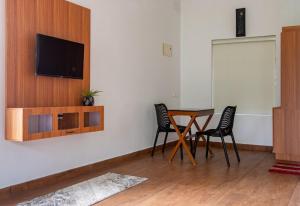a living room with a table and two chairs at Vega Paradise in Kanthalloor