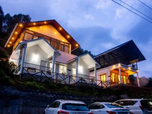 a house with cars parked in front of it at Vega Paradise in Kanthalloor